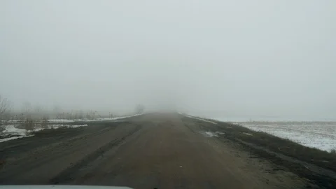 Winter landscape. View through windscreen of a car driving on country road. 4K Stock Footage 126134008