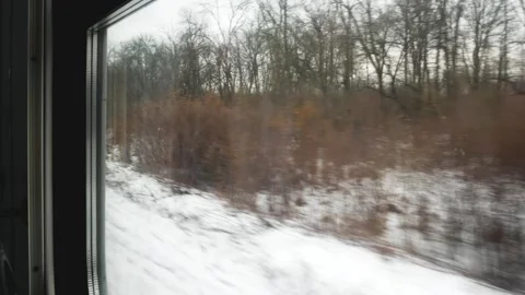 Winter landscape from the window of a moving train. View from the train window. Stock Footage 262237331