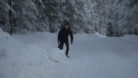 Winter landscape. Young man is running in winter woods. 120fps Stock Footage 88651765