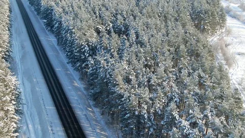Winter landscape,road and snow covered trees. Aerial view of highway among the Stock Footage 120986853