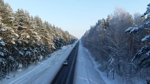 Winter landscape,road and snow covered trees. Aerial view of highway among the Stock Footage 120987301