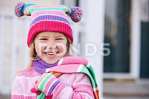 Winter: laughing girl in winter clothing Stock Photos