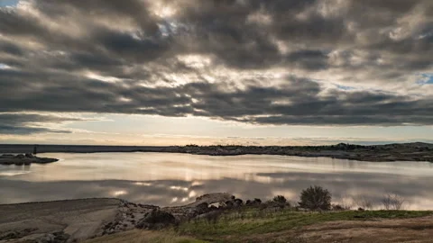 Winter Light Accentuates Languid Clouds above Dismal Reservoir Stock Footage 282533506