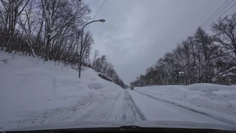 Winter local road driving with snowfall snowbanks and passing van Hokkaido Japan Video stock 333091502