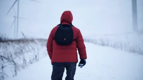 In winter man with backpack walk along in mountains snow lifestyle equipment Stock Footage 105204741