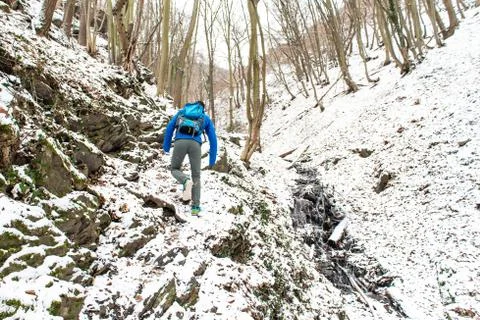Winter Man hiking trekking in white forest. Travel recreation fitness and hea Stock Photos