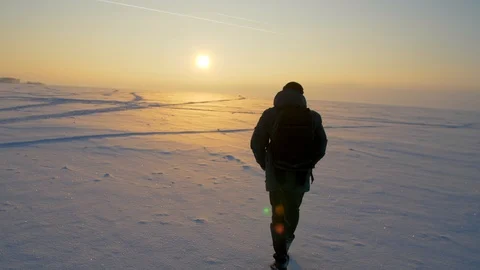 In winter, a man walks through the snow. One man walks on a snowy plain 스톡 동영상 102440509