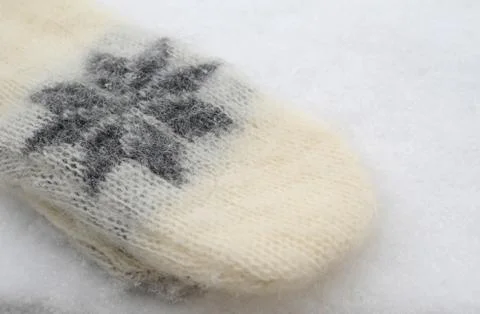 Winter Mitten on Snowy Surface Stock Photos