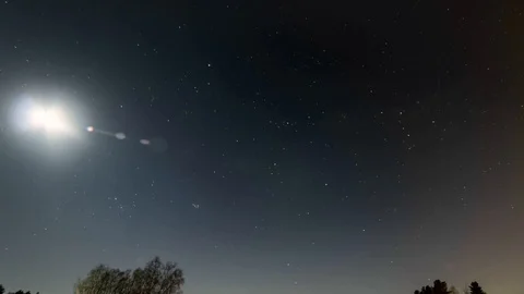 Winter moon and stars move over field at Swedish countryside, timelapse Stock Footage 89960732