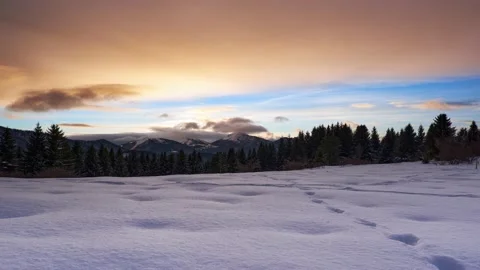 Winter mountain forest landscape at sunset. Clouds over the snowy mountains Video stock 168284276