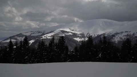 Winter mountain landscape panning shot. Snow covered mountain with trees in Stock Footage 87828229