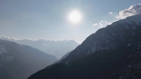 Winter Mountain Range with Bright Sunburst Drone Footage Stock Footage 331765117
