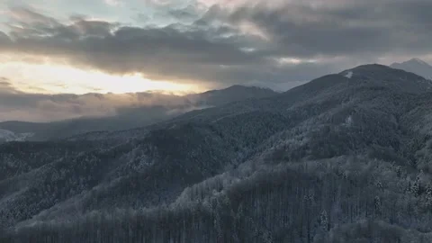 Winter mountain range peak covered in snow sunrise cloudy sky aerial view Stock Footage 171390444