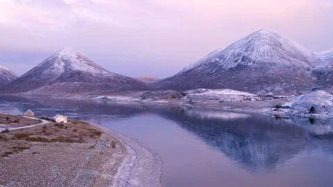 Winter mountain reflections and house on shoreline on very cold day. Drone, 4K Stock Footage 88875227