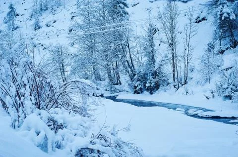 Winter mountain river after the snowfall Stock Photos