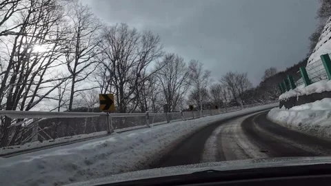 Winter mountain road S curve retaining wall and tower Japan 스톡 동영상 333205041