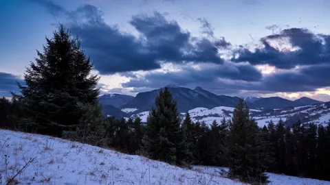Winter mountain rural landscape. Clouds at dusk. end of the day. Pines and Stock-Footage 168753971
