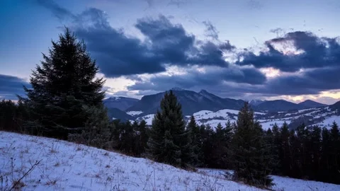 Winter mountain rural landscape. Clouds at dusk. end of the day. Trees in the Видео 169596729