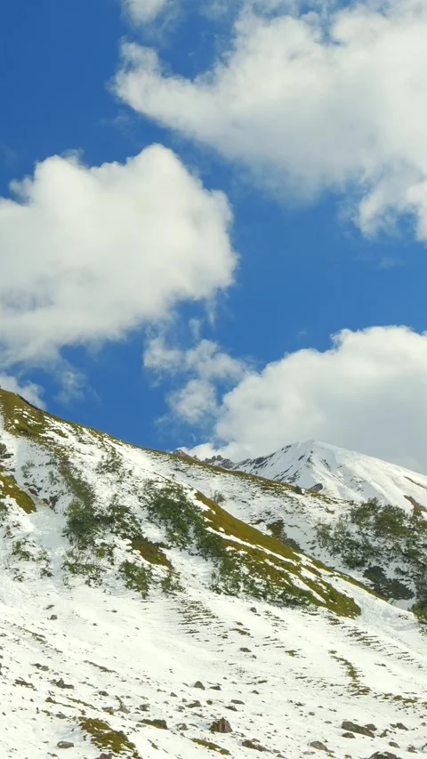 Winter Mountain Silence with Steep Snowy Wall under Blue Sky near Jochgern in Stock Footage 308296440