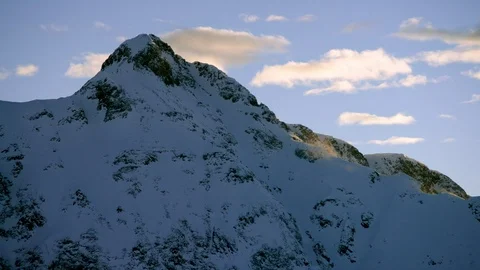Winter mountain summit in snow and cloudy blue sky background Stock Footage 121578321