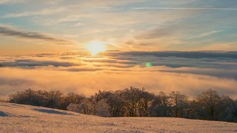 Winter mountain Time lapse above snowy mountain at sunset sunrise over clouds Stock Footage 92993380
