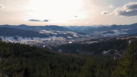 Winter mountain valley view through pine forest, Snow-covered mountain village Stock Footage 305823477