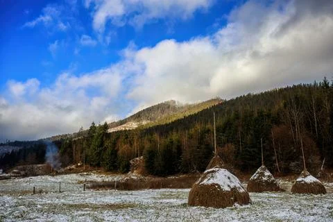 Winter mountains and haystack, cloudy sky. Carpathians Stock Photos
