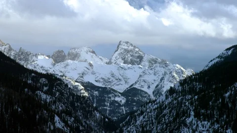 Winter mountains in deep snow with cloudy sky panorama during day time Stock Footage 121578392
