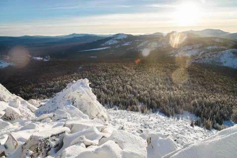 Winter mountains landscape on a bright sunny day with sunlight and glare. Stock Photos