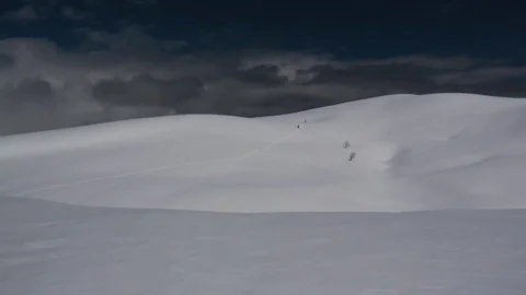 Winter mountains landscape. Two lonely people goes on the slope. Stock-Footage 83664442