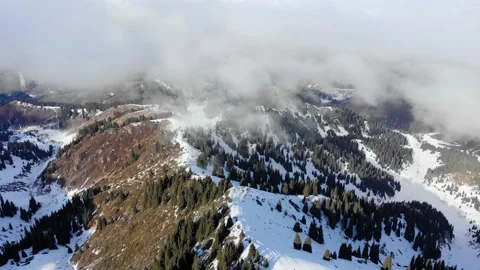 Winter in the mountains. The mountains cover the clouds Stock Footage 168904338