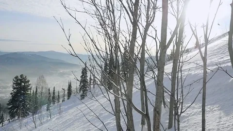 Winter mountains panorama with ski slopes through the sun in Sheregesh in slow Stock Footage 70591529