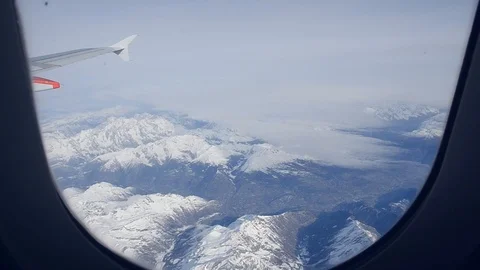 Winter mountains from the plane window Stock Footage 99059913