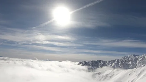 Winter mountains with snow, clouds and sunshine. Hakuba filmed from top lift Stock Footage 86560129