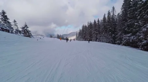 Winter mountains view, POV. Riders on pistes of alpine skiing resort. Vídeo Stock 60775083
