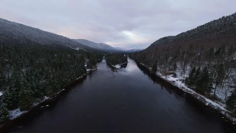 Winter mountainside glide over river Stock Footage 321179159