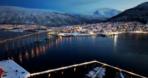 Winter night aerial view over Tromsoysundet of snowy Tromso city and bridge Vídeo Stock 323915936