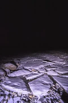 Winter Night Broken Ice Slabs and Snow on Frozen Lake Surface Stock Photos