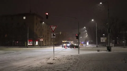 Winter night crash at snowy intersection with tow truck and red lights 스톡 동영상 326194464