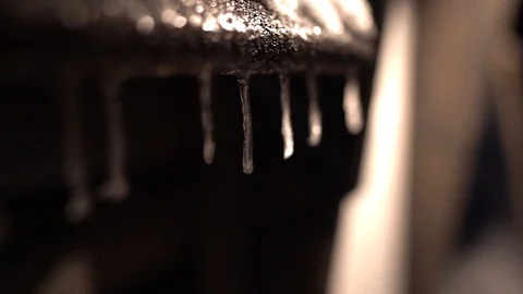 Winter night scene of icicles hanging from roof Stock Footage 128950283