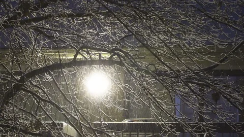 Winter night snow falls in the small town by snowy night Stock Footage 98011750