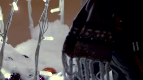Winter outside it's snowing.little boy child is playing with christmas fir tree Video stock 219737460