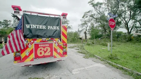Winter Park, FL firefighters clear fallen trees from the street after Hurricane Stock Footage 80361460