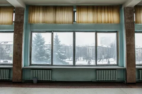 Winter park trees through retro soviet windows architecture Foto stock