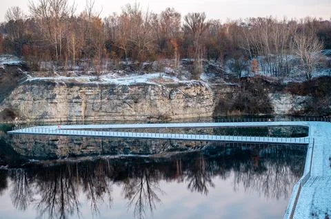 Winter Path by the Lake with Cliffs and Trees Stock Photos