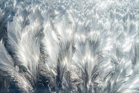 Winter pattern of frost on the window glass Stock Photos