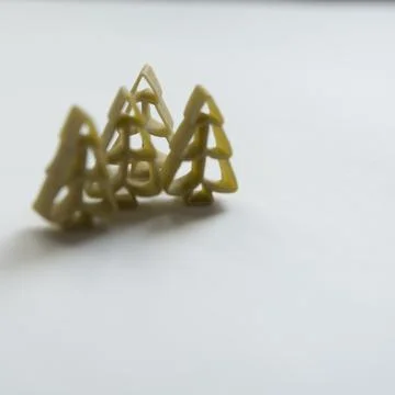 Winter pattern. Green tree shaped pasta Stock Photos