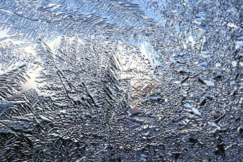 Winter pattern of ice crystals on glass Stock Photos