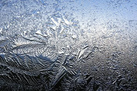 Winter pattern of ice crystals on glass Stock Photos