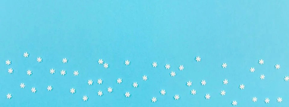 Winter pattern made of small white snowflakes Stock Photos